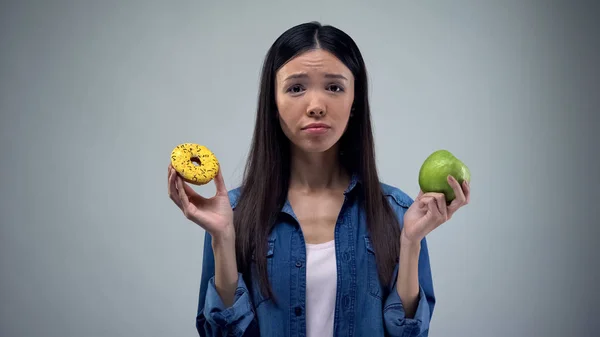 Hungry Girl Trying Choose Donut Apple Healthy Eating Temptation — Stock Photo, Image