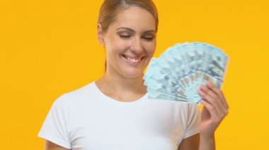 Neşeli kadın dolar demet, karlı kredi koşulları işaret