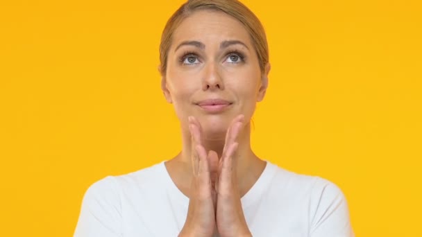 Beautiful woman putting palms together and looking up, hoping for luck, wish — Stock Video