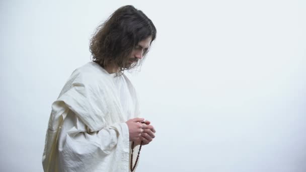 Heiliger Mann betet mit Rosenkranz, Licht fällt als Zeichen der Vergebung, Erlösung — Stockvideo