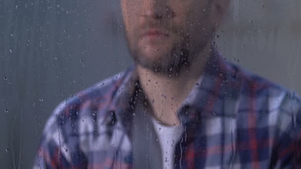 Lonely depressed male looking in window on rainy day, life troubles, sadness — Stock Video