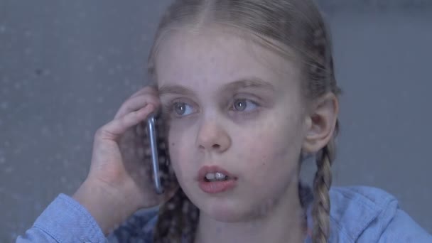 Depressed girl talking on phone suffering loneliness, missing occupied parents — Stock Video