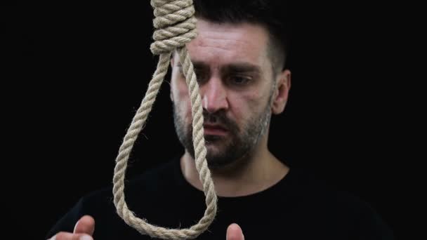 Desperate man wearing loop on neck, suicide prevention concept, risk of death — Stock Video