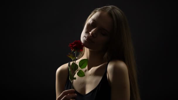 Beautiful woman holding red rose, romantic present from beloved, femininity — Stock Video