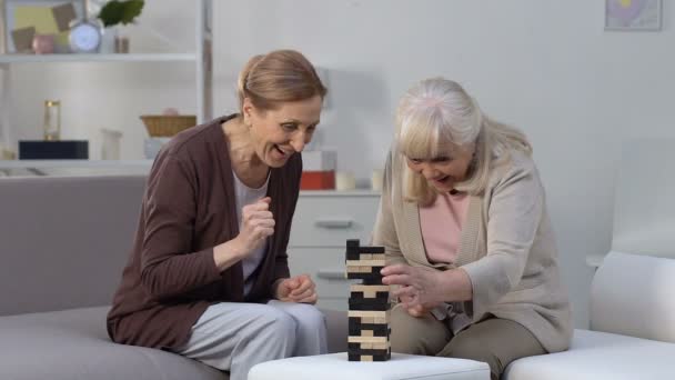 Elderly females playing block game having fun in nursing home, retirement hobby — Stock Video