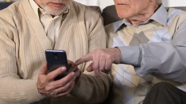 Two old men using smartphone closeup, mobile banking application, technology — Stock Video