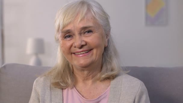 Happy elderly female smiling and looking at camera, health insurance, protection — Stock Video