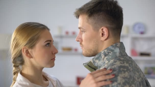 Sad girlfriend hugging male soldier, farewell before military service depression — Stock Video