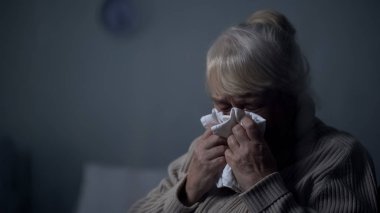 Desperate elderly female deeply crying in dark room, hospice loneliness, problem clipart