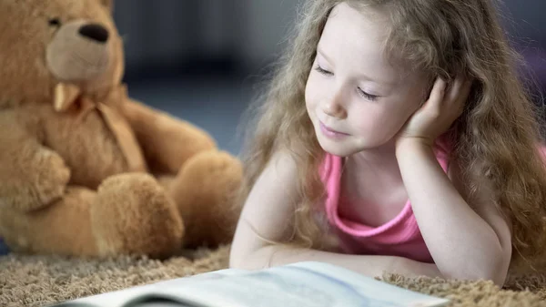 Concentrated Cute Girl Reading Book Lying Carpet Preschool Education — Stock Photo, Image