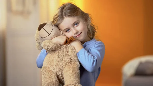 Cute Curly Haired Blond Girl Hugging Teddy Bear Smiling Camera — Stock Photo, Image