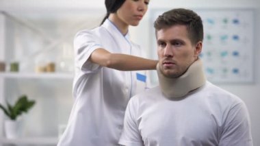 Kadın ortopedist sabitleme erkek hasta köpük servikal yaka travma sonucu, rehabilitasyon