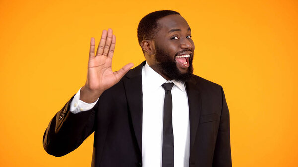 Joyful childish afro-american sales manager waving hello, promo campaign, ad