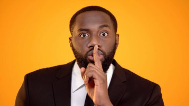 Afro-Amerikan adam takım elbiseli sessiz işaret yapma, seçim sessizlik, gizlilik