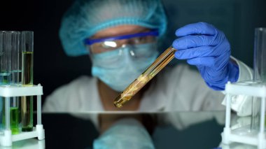 Mikrobiyolog koruyucu Ajan doku örneği okuyor, dekompozisyon hızı