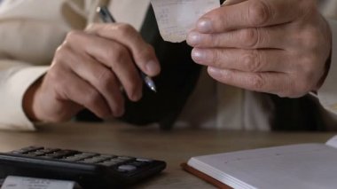 Yaşlı erkek tutarak faturaları, gelir ve giderleri, ekonomi hesaplanması