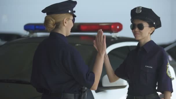 Policewomen giving high five and walking to police station, well done duty — Stock Video