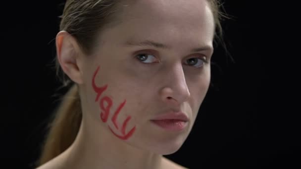 Determined woman wiping ugly word written on face, fighting social opinion — Stock Video