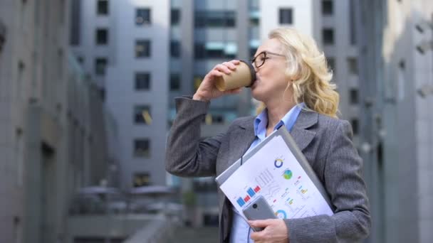 Volwassen Business Lady documenten in de hand drinken van koffie en glimlachen, inspiratie — Stockvideo