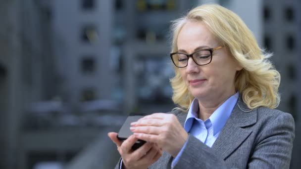 Happy beautiful lady in suit looking in small mirror, satisfied with reflection — Stock Video