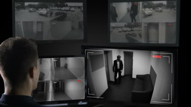 Männlicher Sicherheitsbeamter beobachtet Überwachungskameras, illegales Geschäft — Stockvideo
