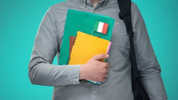 Student holding notebooks with Italian flag, international education program — Stock Video