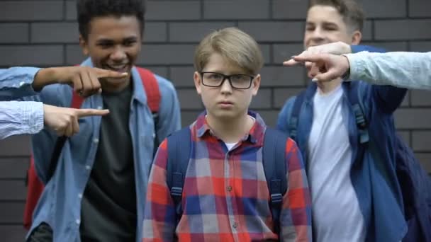 Bullied boy looking at camera, depressed by classmates mockery, verbal abuse — Stock Video