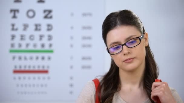 Успешная симпатичная студентка-офтальмолог в очках, улыбающаяся в камеру — стоковое видео