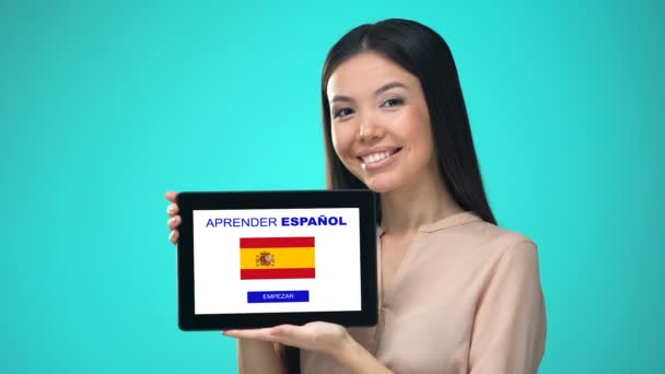 Female holding tablet with learn spanish application, ready to start course — Stock Video