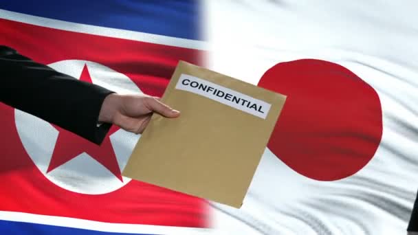 North Korea and Japan officials exchanging confidential envelope, against flags — Stock Video