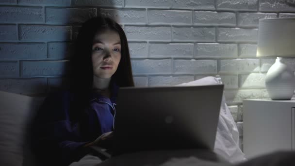 Girl using laptop and cellphone to synchronize account data, online applications — Stock Video