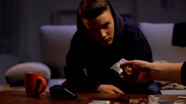 Drug dealer offering addicted teenager weed dose, criminal activity, abuse clipart