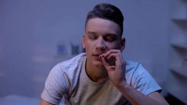 男性青少年吸烟杂草关节 晚上在家里 尴尬的年龄实验 — 图库照片