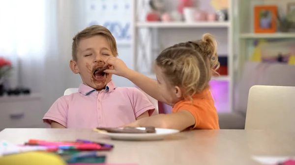 Happy Sister Feeding Brother Smeared Chocolate Sugar Overeating Caries — Stock Photo, Image