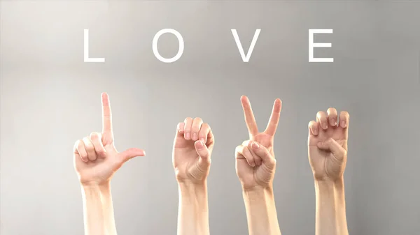 Love word written and shown with hands in deaf asl language, expressing feelings