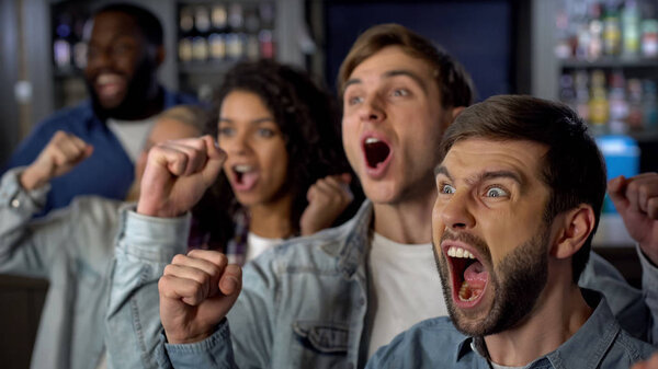 Cheering group of sport fans rejoicing team victory, watching match together