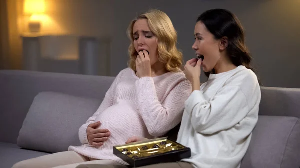 Woman Sitting Upset Pregnant Friend Eating Chocolate Candies Hormones — Stock Photo, Image