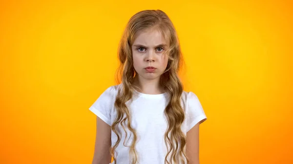 Zdenerwowany Poważna Dziewczyna Szuka Aparatu Frown Izolowane Pomarańczowym Tle — Zdjęcie stockowe