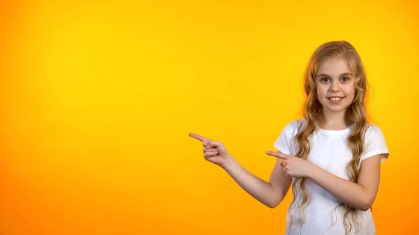 Smiling Girl Pointing Orange Background Advertisement Template Promotion — Stock Photo, Image