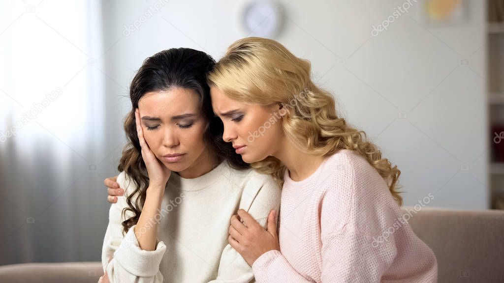 Woman supporting her upset friend, depression after braking up with boyfriend