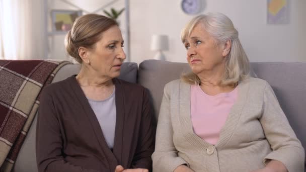 Mature friends supporting and comforting each other sitting on sofa pain of loss — Stock Video