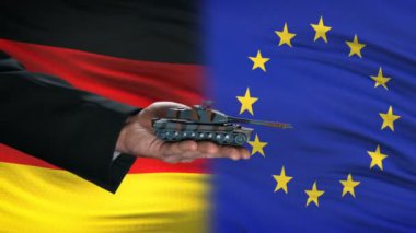 Almanya ve Avrupa Birliği yetkilileri para, bayrak arka plan, işbirliği için tank alışverişi