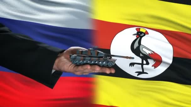 Rusia y Uganda intercambian tanque por dinero, fondo de la bandera, acuerdo — Vídeos de Stock