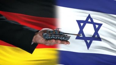 Almanya ve İsrail yetkilileri para, bayrak arka plan, anlaşma için tank alışverişi