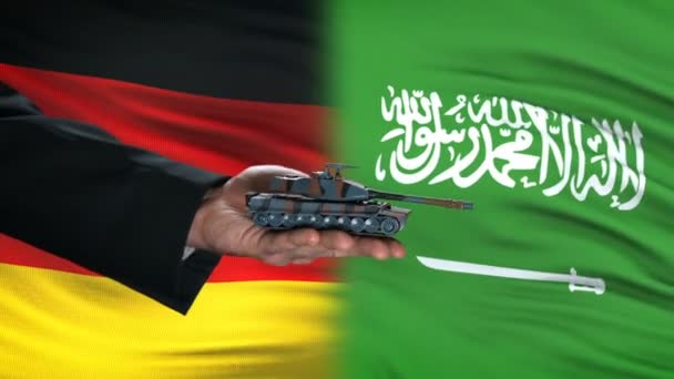 Deutschland und saudi-arabische Beamte tauschen Panzer gegen Geld, Fahnenhintergrund — Stockvideo