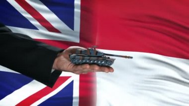 Büyük Britanya ve Endonezya yetkilileri para için tank alışverişi, bayrak arka plan