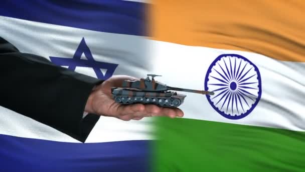 Israel and India officials exchanging tank money, global arms, flag background — Stock Video