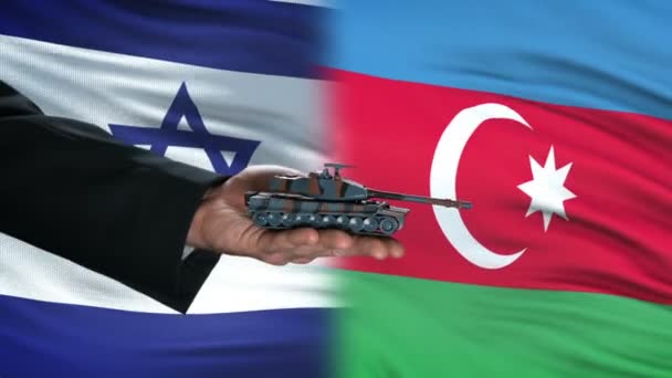 Israel and Azerbaijan officials exchanging tank for money, flag background, army — Stock Video