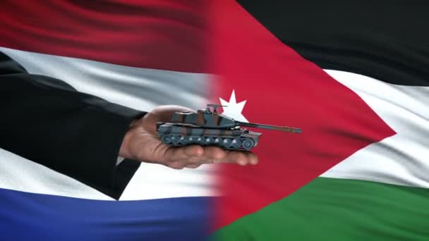 Nederland en Jordanië ambtenaren uitwisselen van tank voor geld op vlag achtergrond — Stockvideo