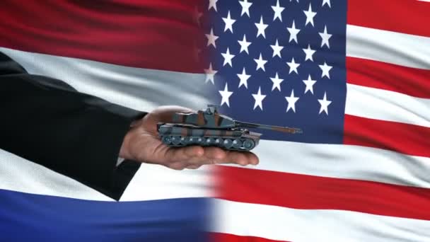 Netherlands and USA officials exchanging tank money, flag background, politics — Stock Video